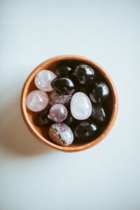 a bowl filled with lots of rocks on top of a table